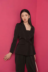 Tailored silk blazer with structured lapel and waist tie detail for modern formalwear